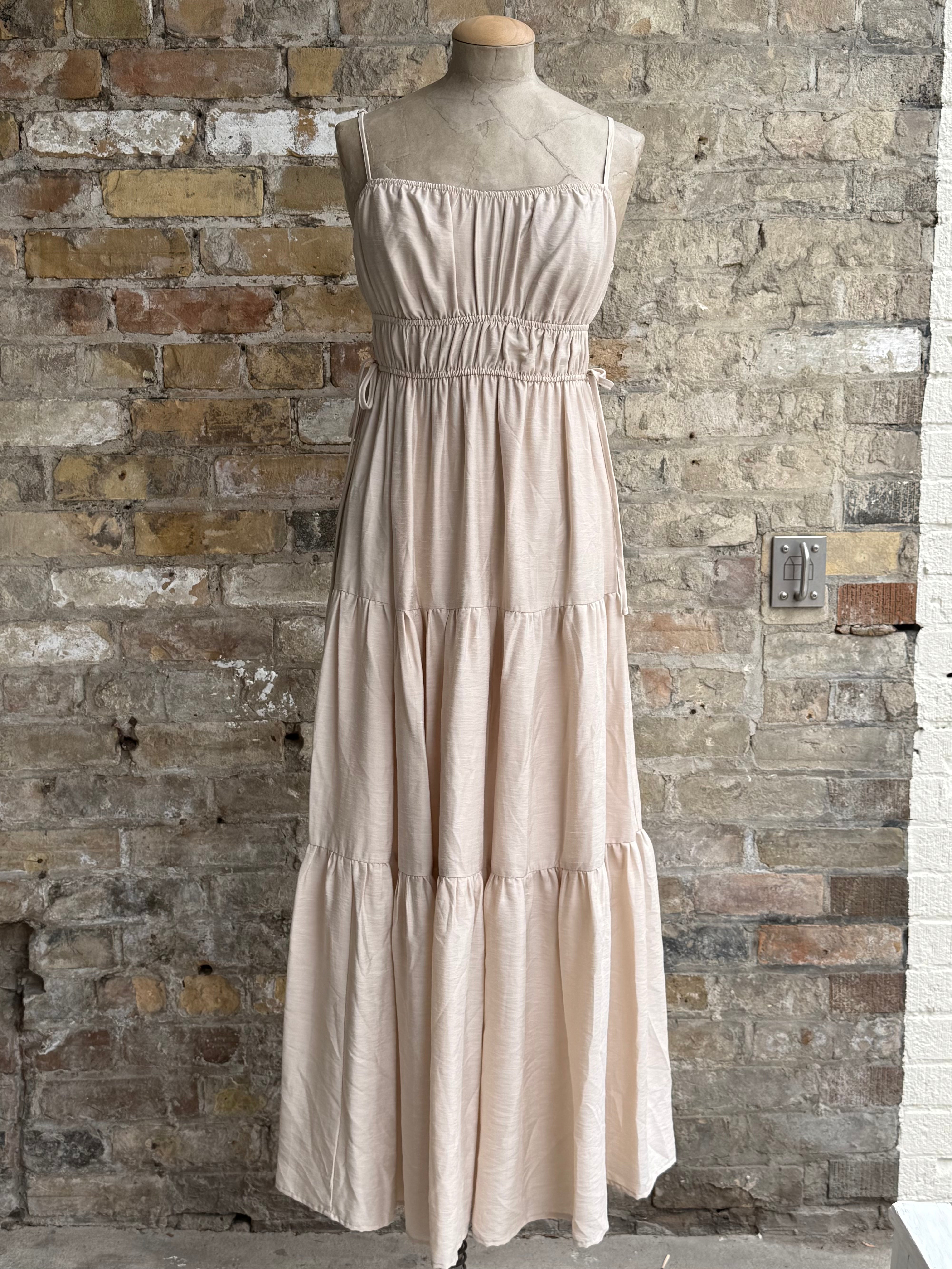 Beige dress with buns on the sides