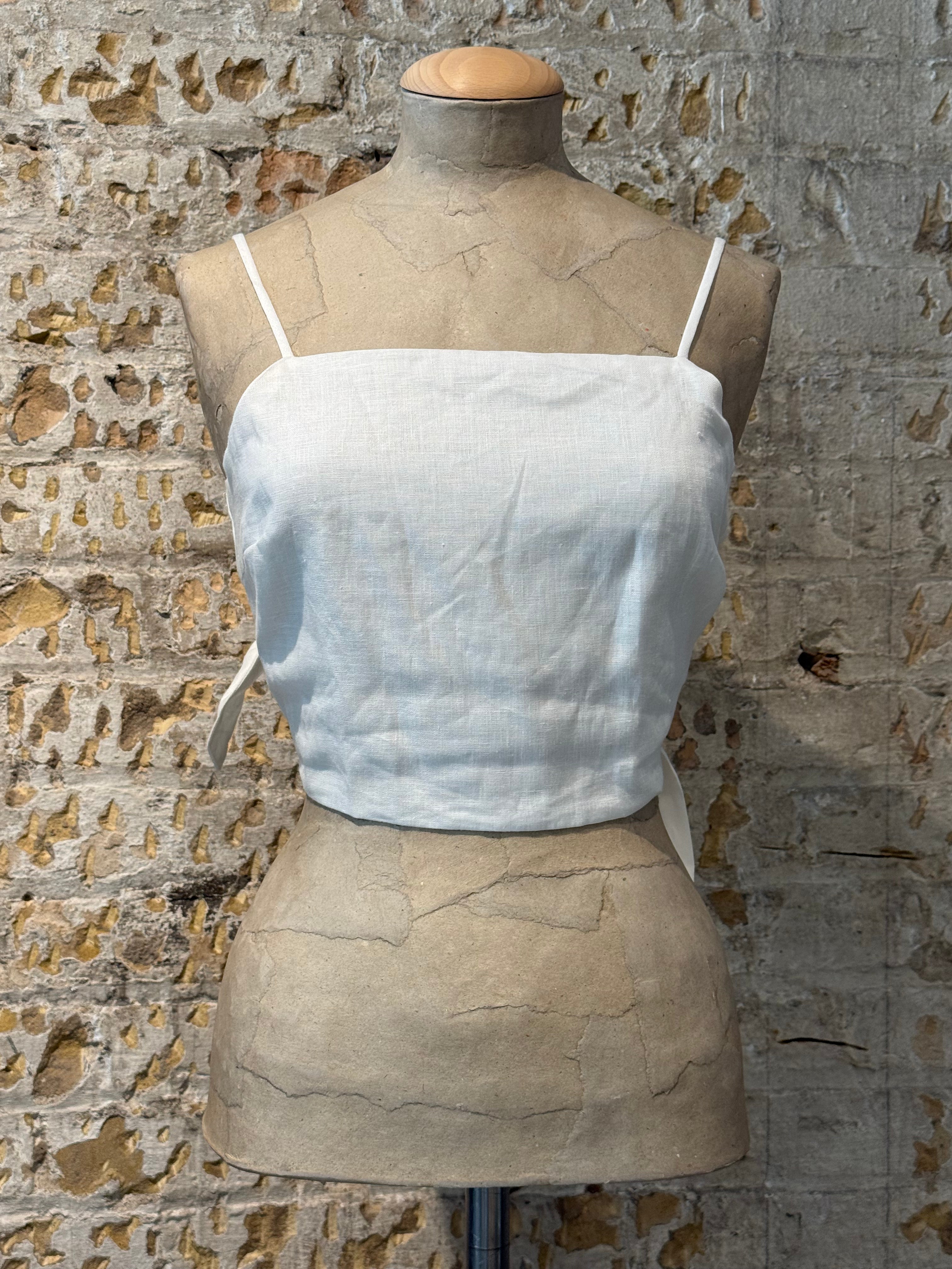 White top cut with bow on the back