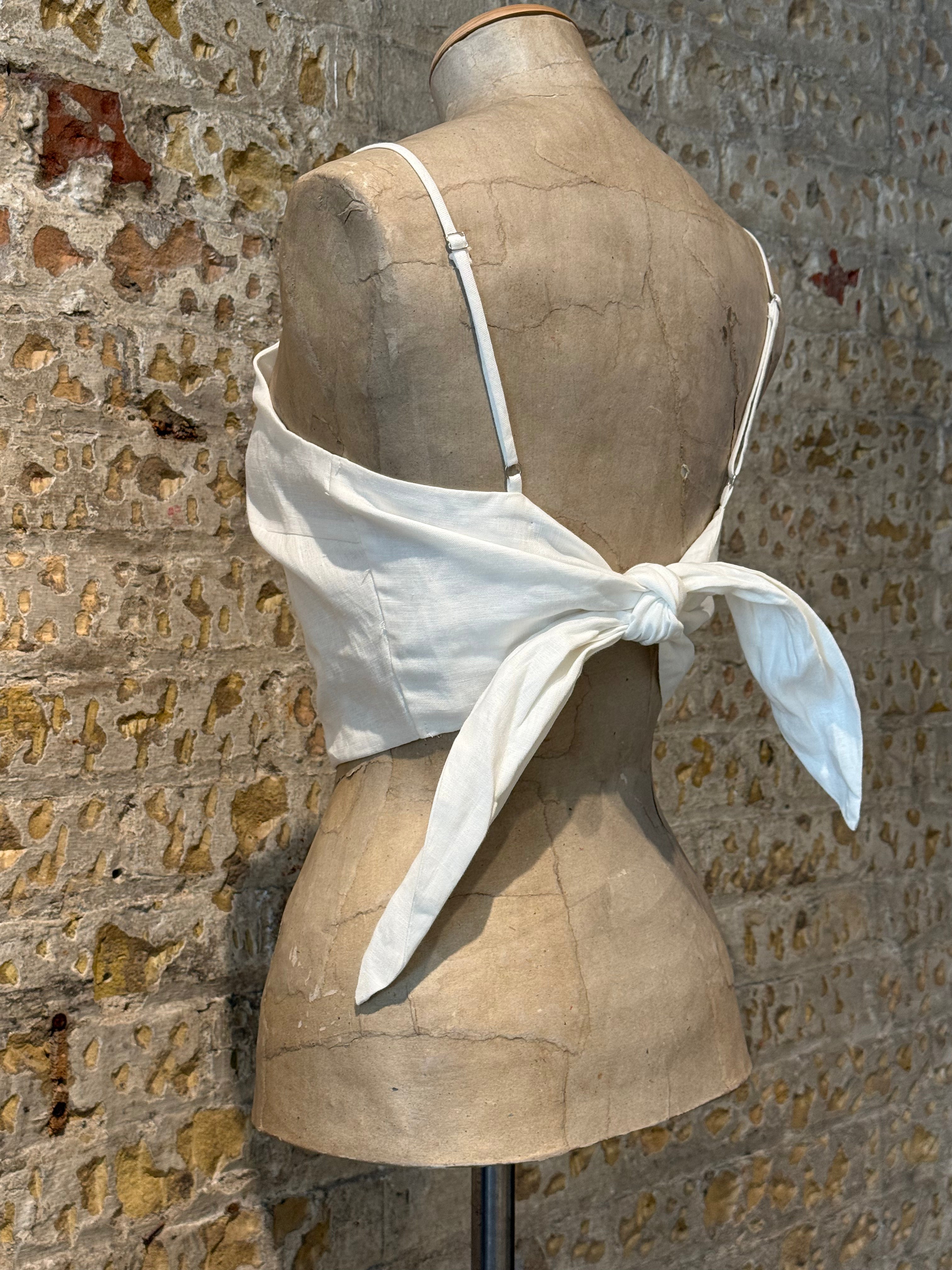 White top cut with bow on the back