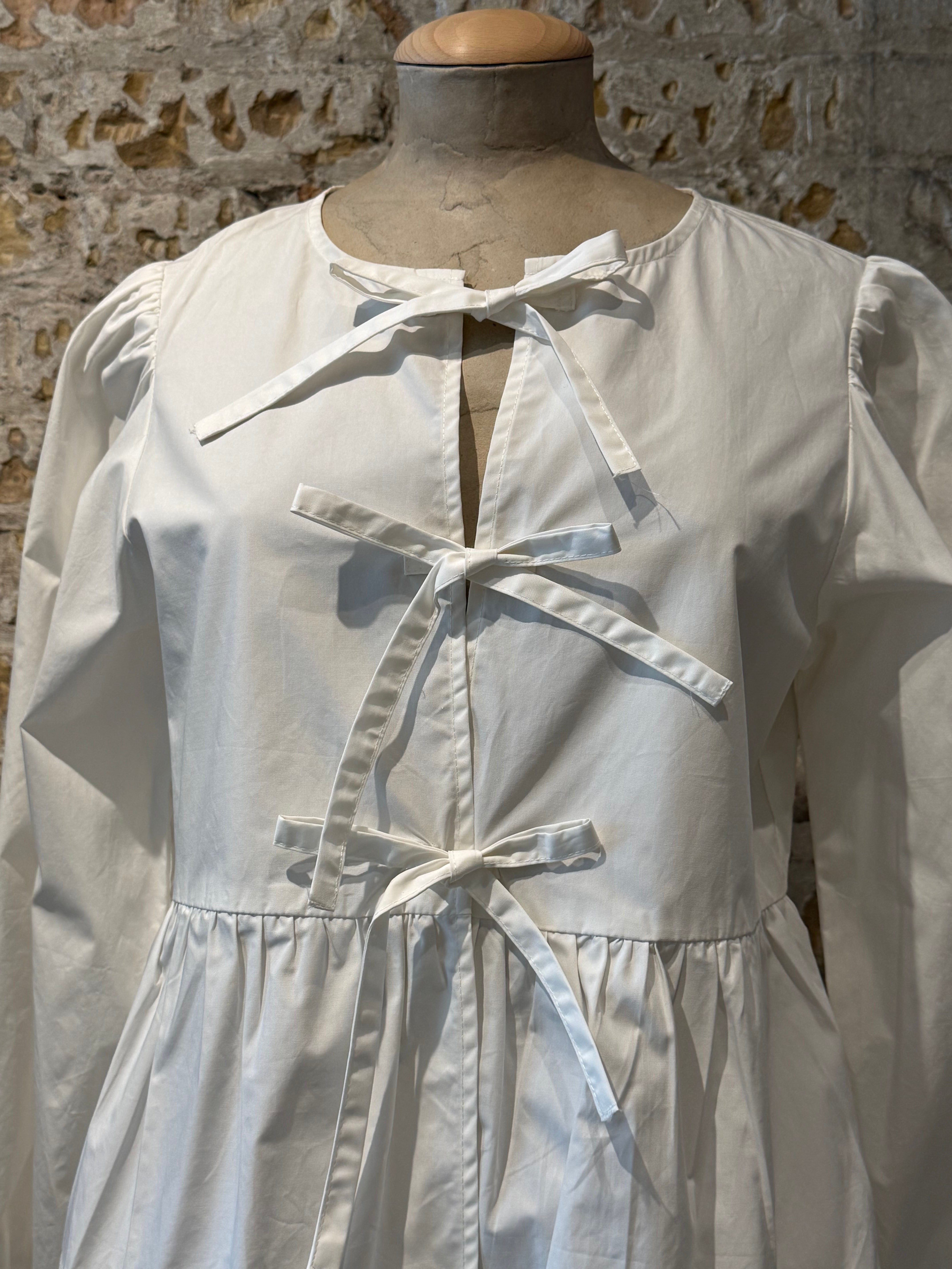 White top with bows on the front