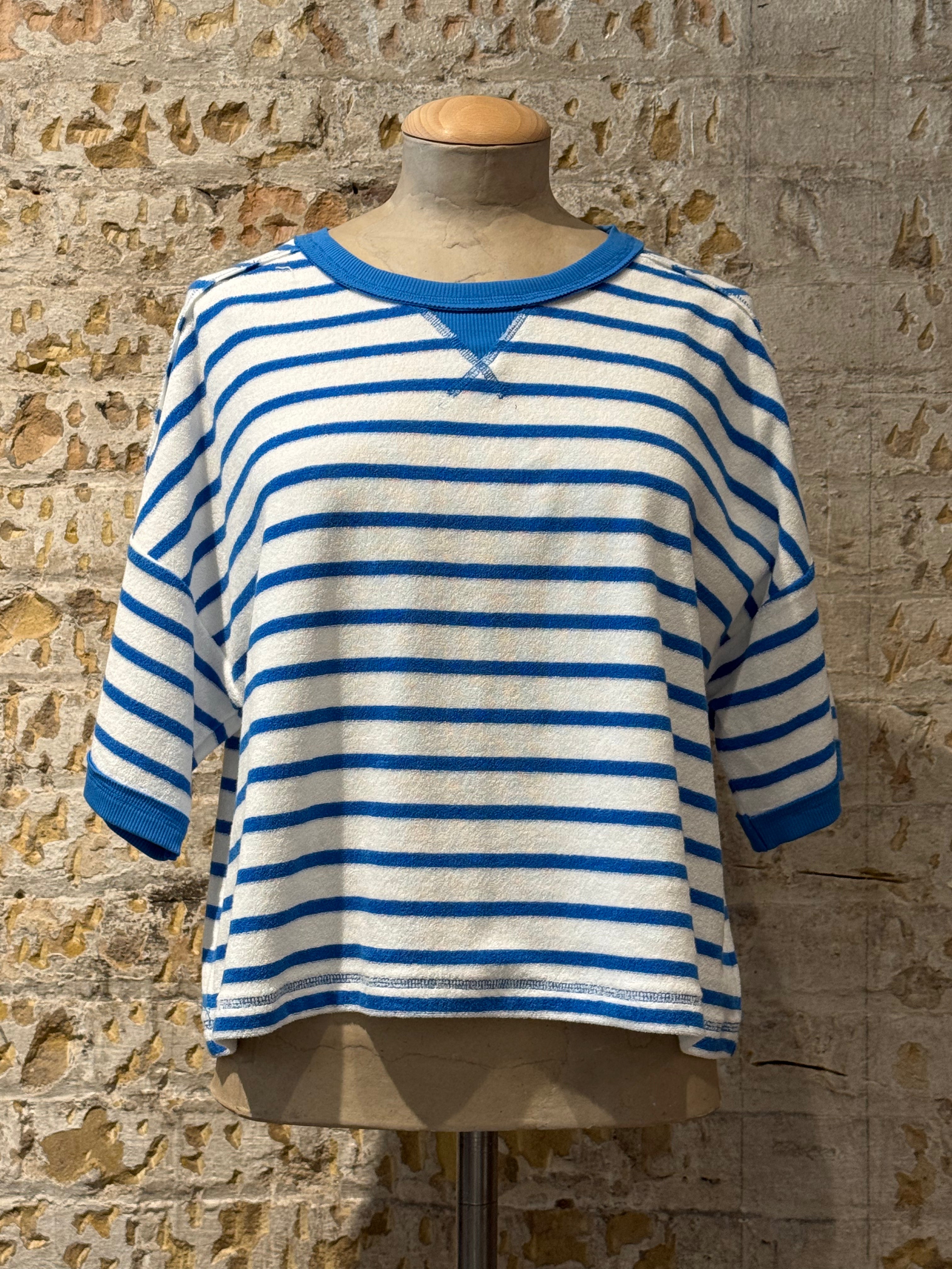 White top with horizontal blue stripes