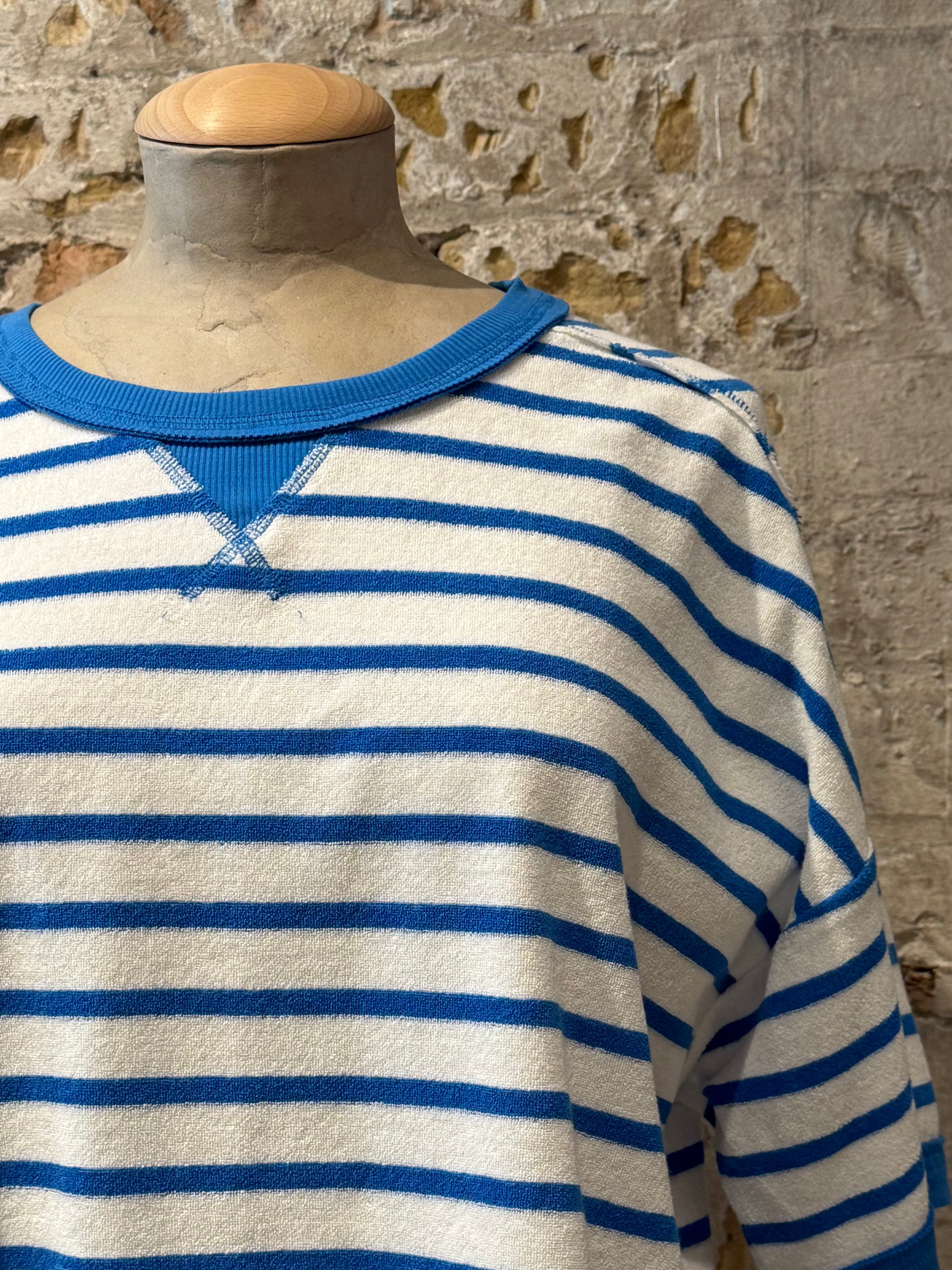 White top with horizontal blue stripes
