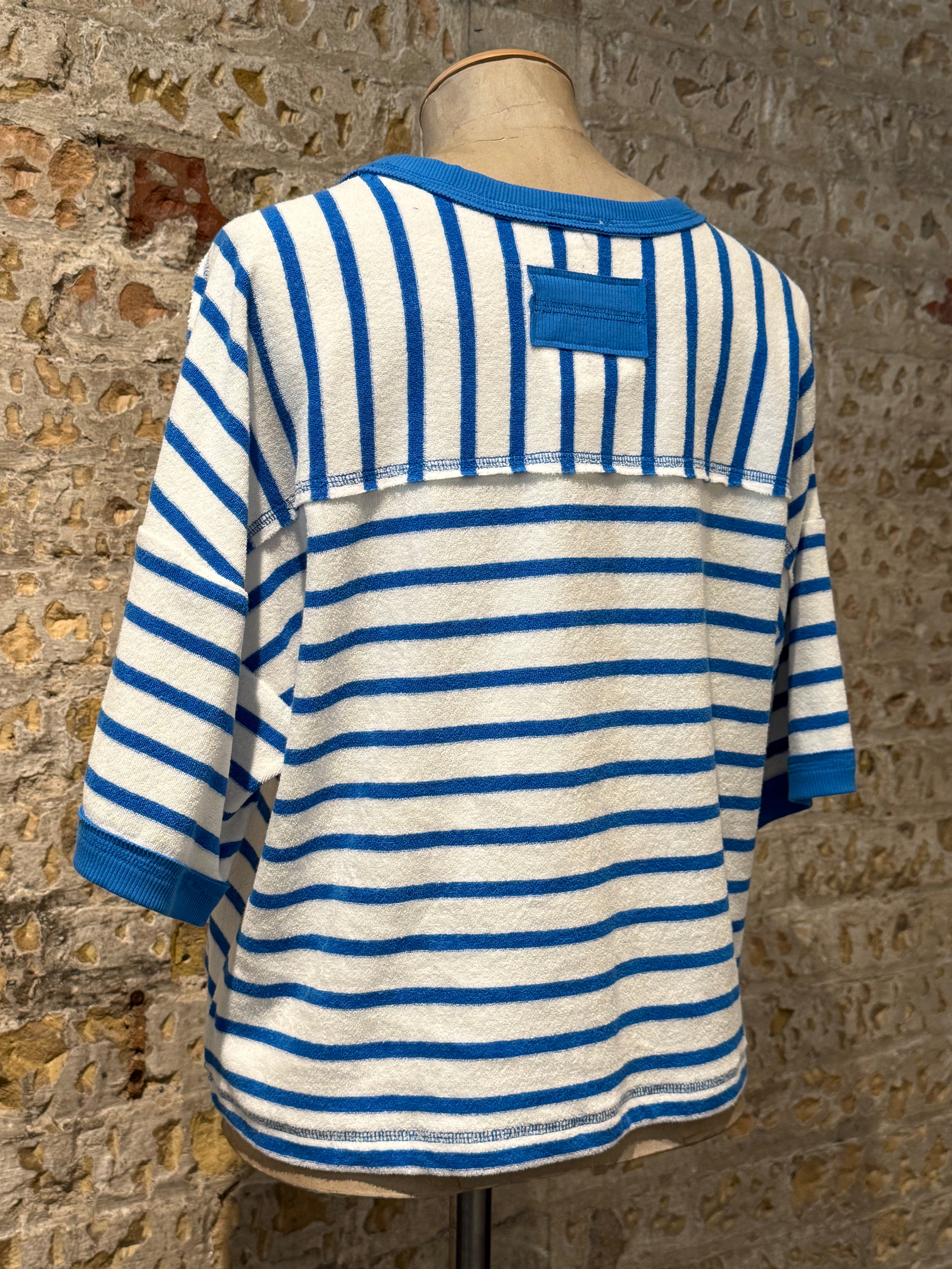 White top with horizontal blue stripes