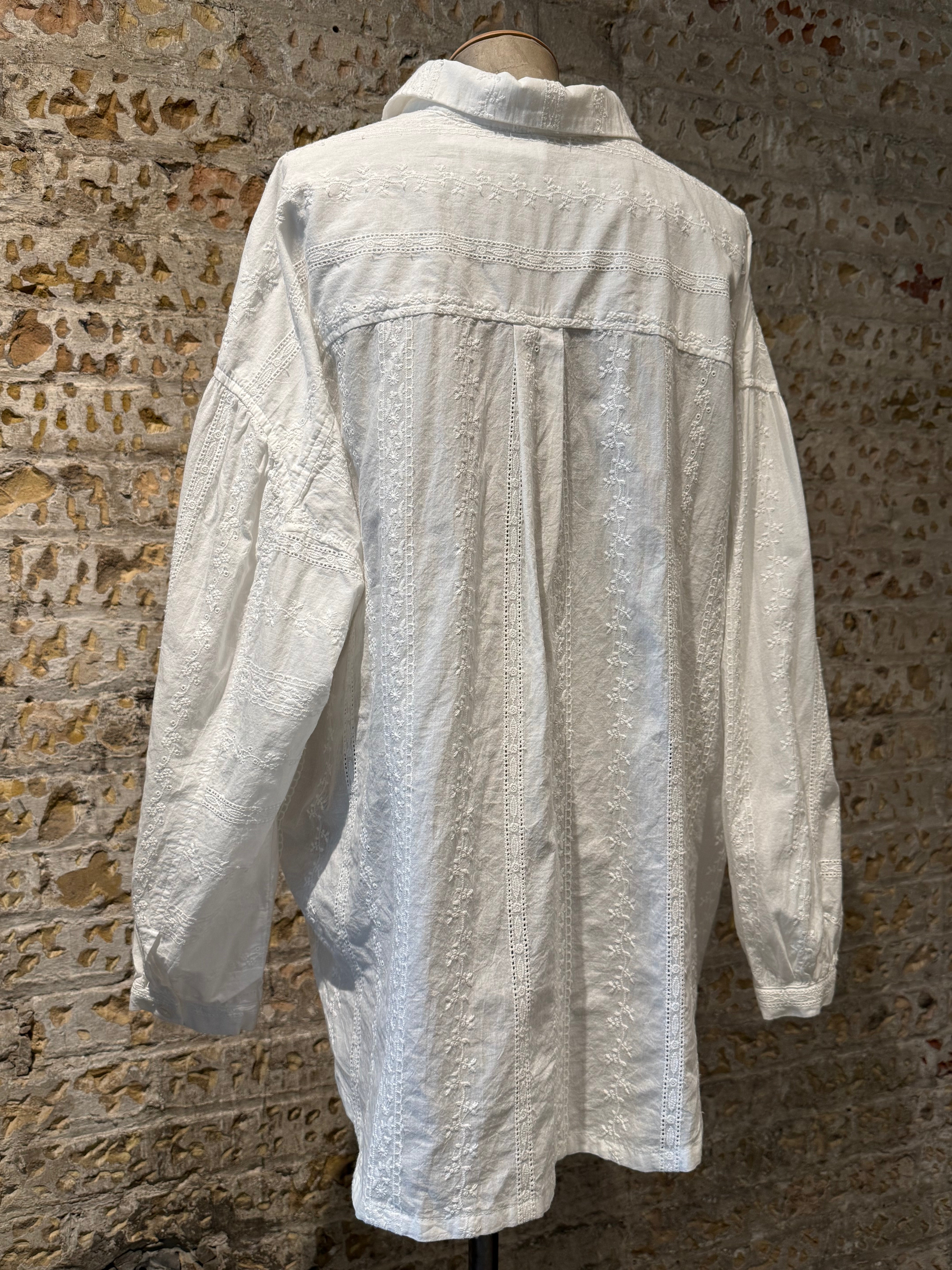 White long sleeve blouse and boot with cute details on blouse