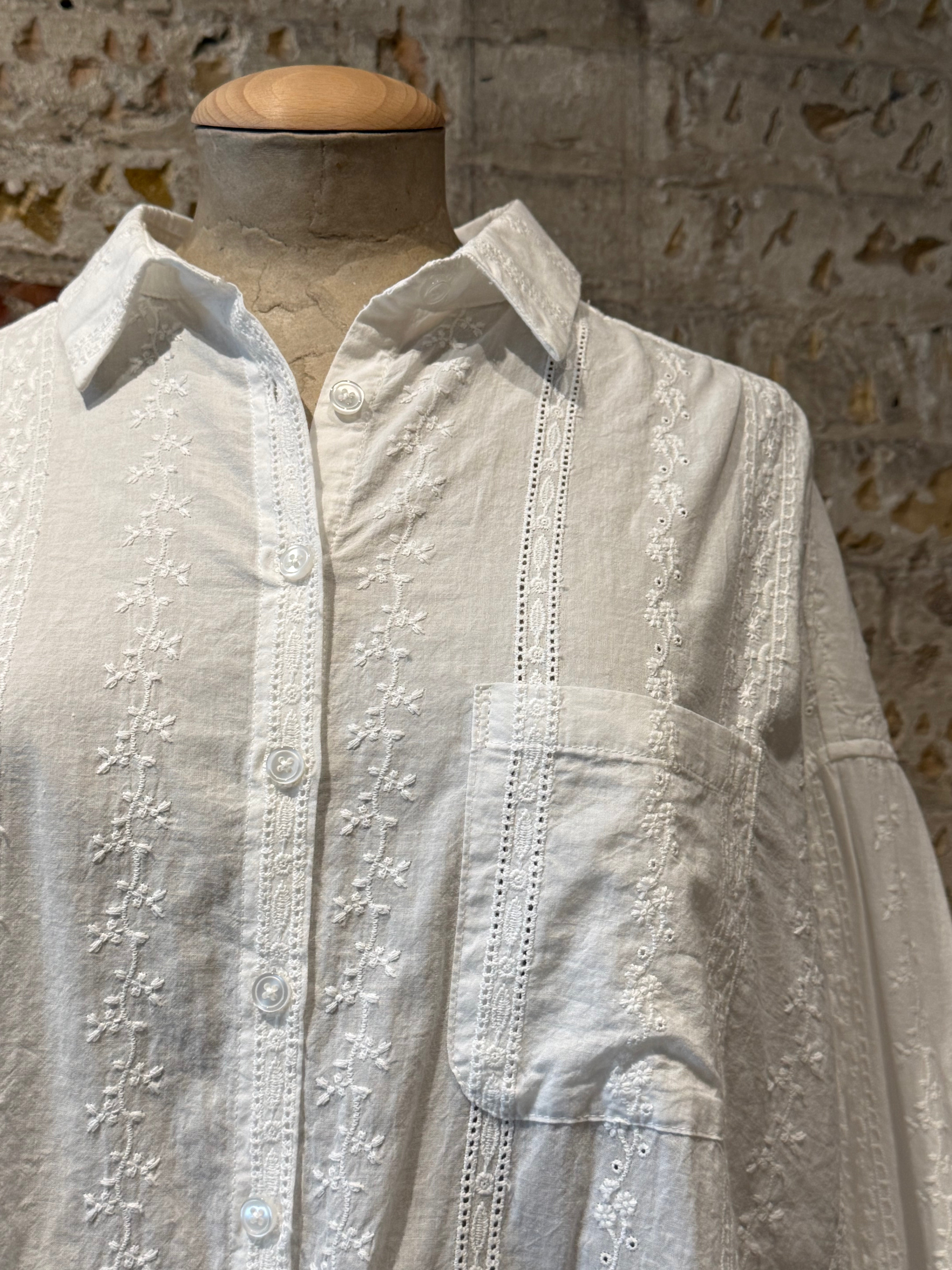 White long sleeve blouse and boot with cute details on blouse